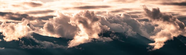 sea spray, breaking waves, sunlight, ocean surface, cloud bank