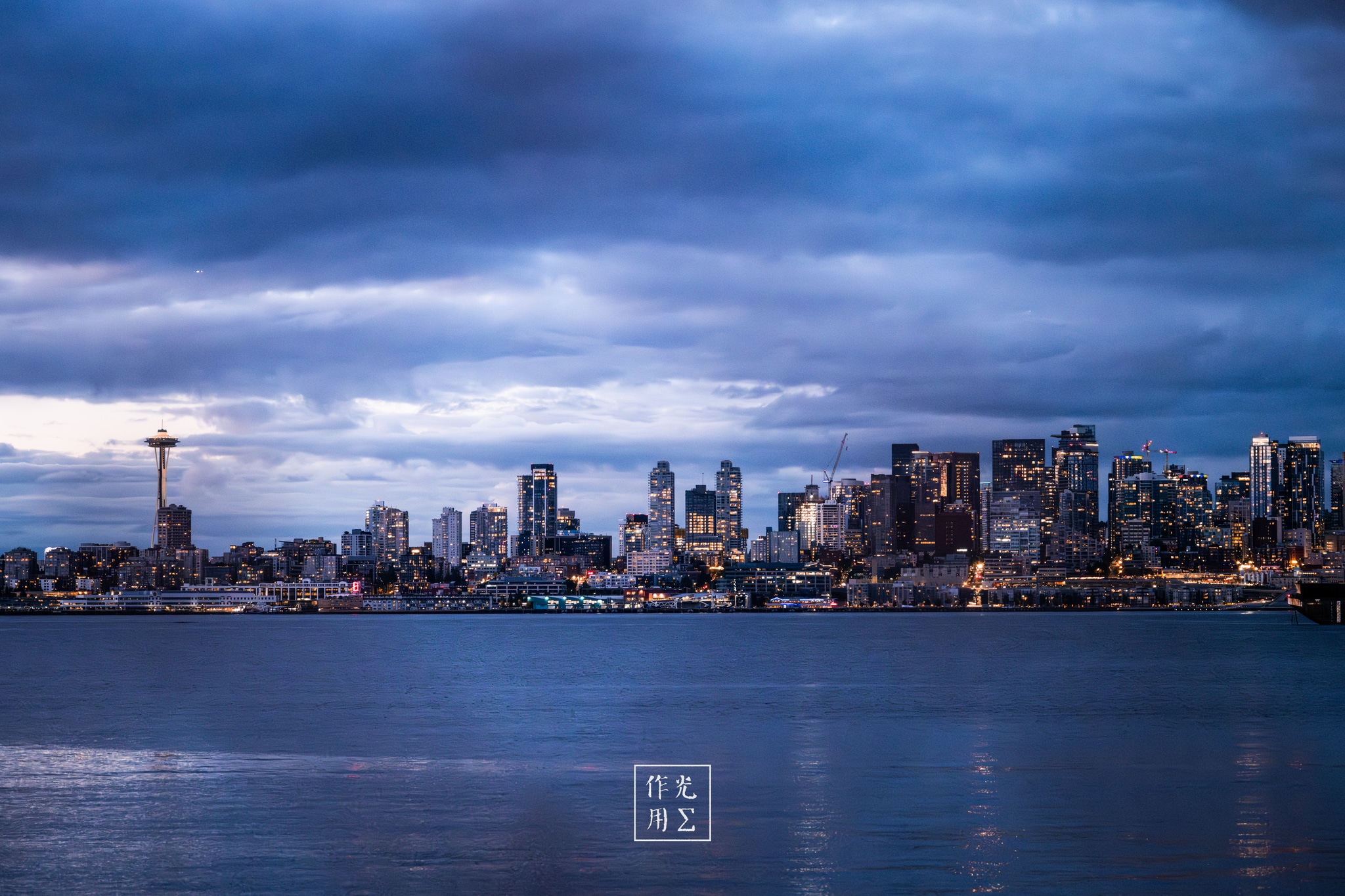 city skyline, water, cloud-filled sky, light reflections, observation tower