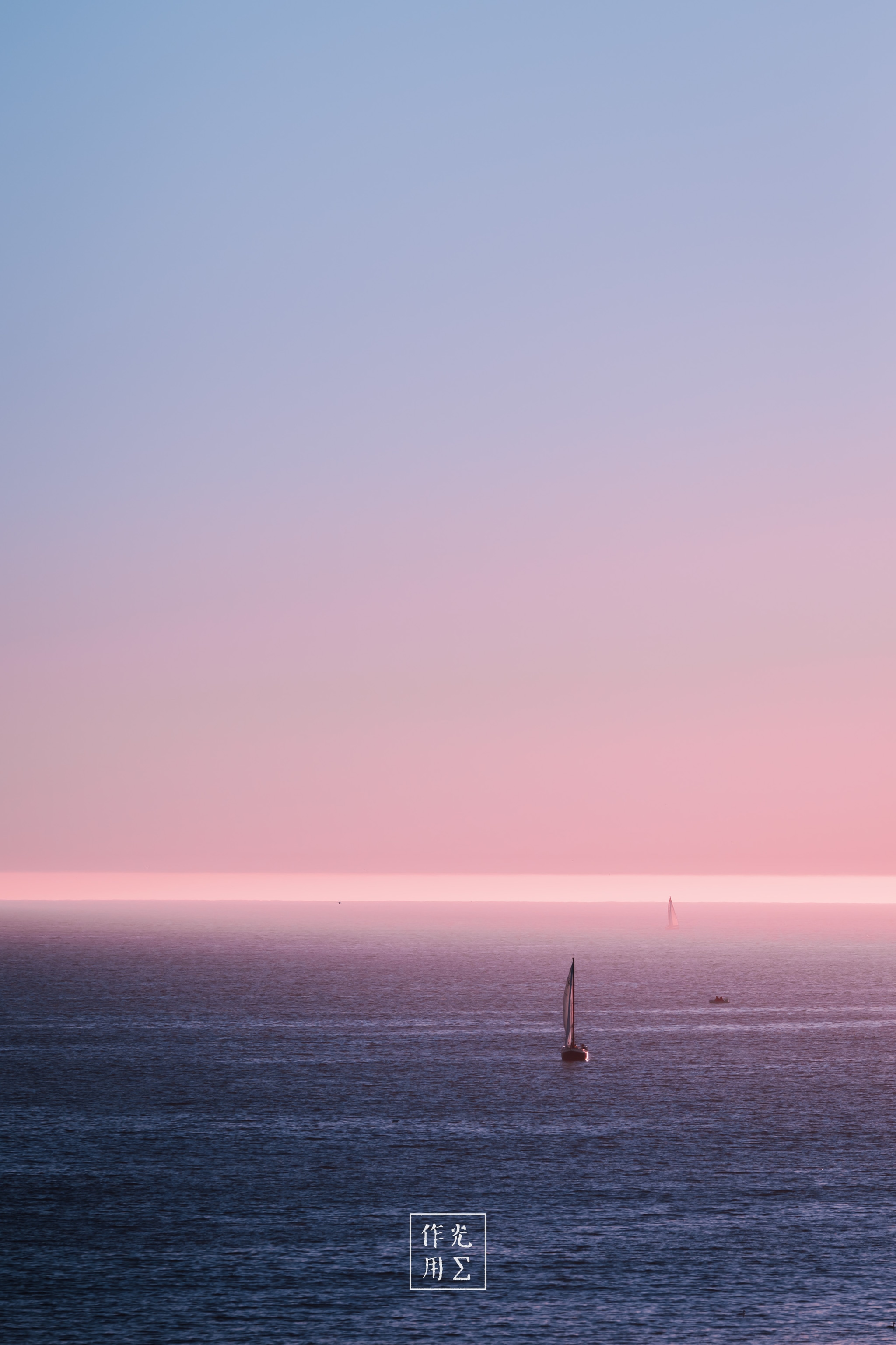 Drifting across a vast expanse of glassy water, a lone sailboat punctuates an ethereal horizon painted in pastel pinks and powder blues. Crisp horizontal bands of color blur sky and sea into one seamless canvas, while the tiny silhouette of the mast lends a whisper of human presence to the serene, almost otherworldly calm